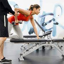 Personal Trainer Working With A Client In The Gym Doing Rows No Equipment Workout Workout Training Programs Gyms Near Me