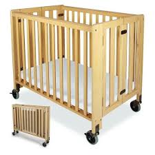 Hideaway Folding Baby Crib Compact Size Cherry Finish Cribs Hideaway Compact Size Daycare Folding Cribs By Foundations Th Wood Crib Cribs Portable Crib
