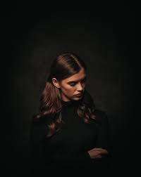 It's always a good idea. Photo Of Woman In Black Turtleneck Sweater Posing In Front Of Black Background While Looking Away Free Stock Photo