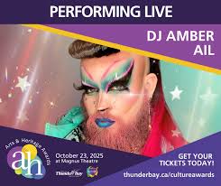 Performing live at the 2025 Arts & Heritage Awards: DJ Amber Ail! Amber Ail  is Thunder Bay's bearded beauty — a celebrated drag queen, DJ, and  community favourite. Blending music, fashion, and