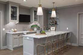 Transform your basement bar zone into an intimate dining space. Gray Wet Bar With Glass And Brass Pipes Shelving Transitional Basement