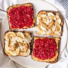 Simple Sweet Breakfast With Mashed Raspberries And Peanut Butter On Rye Toast And Sliced Banana With Almond Butter And Cuisine Vegan Recette Facile Cuisine Bio