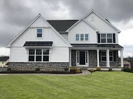 Black shutter for enhancing the aesthetic of a white house. White Double 4 Siding White Board Battan Black Shutters Bull Run Cobble White Siding White Board And Batten Black Shutters