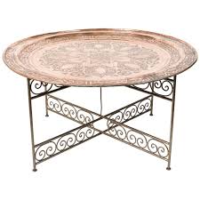 The legs intersect on the floor in the center of the table. Handcrafted Moroccan Moorish Round Copper Tray Table On Iron Base At 1stdibs