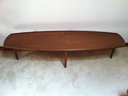 Striking black walnut grain is visible on the top surface. Mid Century Modern Surfboard Coffee Table By Stewart Macdougall For Drexel Declaration Epoch