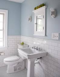 The shower surround in this bathroom is clad in subway tiles and matching white grout, creating an uninterrupted plane of white. Six Ways To Spruce Up A Small Bathroom Easy Remodels You Ll Love White Bathroom Tiles Black And White Tiles Bathroom White Tile Bathroom Floor