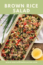 Brown Rice Salad In Oblong Plate With Spring Onions And Lemon Halves Brown Rice Salad Rice Salad Brown Rice Salad Recipe