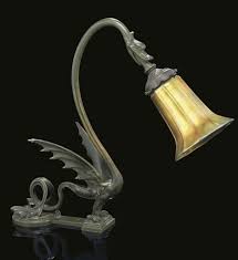 Quezal A Patinated Bronze Dragon Table Lamp With Iridescent Glass Shade Circa 1905 The Base Cast As A Mythical Winged D Art Nouveau Lamps Lamp Dragon Table