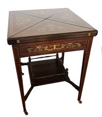 Many card tables are available in sets that include four padded folding chairs. Edwardian Rosewood Envelope Card Table
