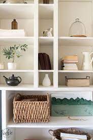 Since the fun, geometric wallpaper is the anchor for the design, white bed linens, floral pillows and colorful stools were added to break up the pattern and bring some additional color into the space, creating an interesting, fun, unique design. Gorgeous Office Bookshelves With A Built In Electric Fireplace Office Bookshelves Built In Electric Fireplace Electric Fireplace
