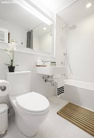 With continuous flooring and white wall tiles throughout the room will freshen the look and make the bathroom appear polished and clean. Before And After Ellen S Kensington Bathroom Renovation Sweetened Sweeten Com Bathrooms Remodel Windowless Bathroom Mold In Bathroom