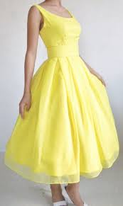 Yellow Dress With A Boat Neckline And Knee Length Pleated Skirt Makes A Beautiful Little Bride Tea Length Bridesmaid Dresses Trendy Dresses Tea Length Dresses