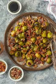 Add the cooked bacon, pour chicken stock and balsamic vinegar over the sprouts, mix and continue to cook until the liquid has thickened. Roasted Balsamic Brussels Sprouts With Bacon And Pecans