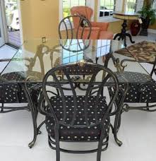 Glass top dining table with wrought iron base. Lot Art Wrought Iron And Glass Top Dining Table And Chairs