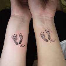 Small heart shaped angel wings tattoo on wrist. 75 Cute Baby Footprint Tattoos For Appreciative Parents