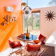 Dining room with orange tiles on the floor and large french door to the garden. 10 Beautiful Bohemian Dining Rooms We Love