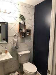 half bath with accent wall and navy paint bathroom accent wall wallpaper accent wall bathroom half bath remodel