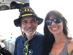 Scuba divers dancing with sea lions