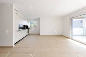 empty room with white walls, travertine