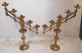 A very large and robust pair of brass candlesticks with elaborately shaped drip pans; Rare Pair Of Brass Gothic Or Church Candelabra Vinterior