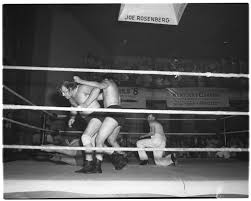 Wrestling matches at Woodland auditorium. Don Evans, Lucky Simunovich and  Referee Frank Bunch. · John C. Wyatt Lexington Herald-Leader photographs