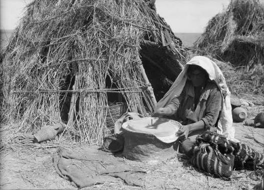 File:Agriculture, etc. Primitive methods of rubbing and grinding wheat. Woman grinding with present-day hand mill. Before her modest home on southern Sharon LOC matpc.15642.jpg - Wikimedia Commons