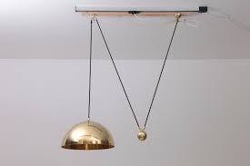 With the pendant light, the mass of the stone and metal acts as a foil to its otherwise lightweight frame, while also allowing control of the height adjustment. Posa Pendant With Counterweight By Florian Schulz
