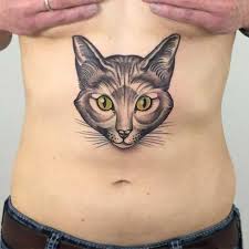 Miley cyrus has a small cat with a leash tattoo on her inner lip in yellow color. Cute Natural Looking Big Cat Face Tattoo On Belly Tattooimages Biz