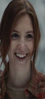 the tall lady with long hair and a big smile is watching you.