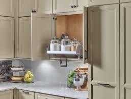 The most common pull down cabinet material is metal. Yorktowne Cabinetry Wall Cabinet Pull Down Shelf