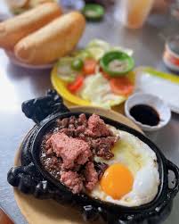 Sizzling bò né steak and eggs breakfast