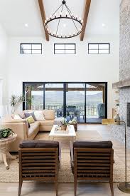 Perhaps your entire living room could use that homey farmhouse touch. Modern Farmhouse Inspiration High Ceiling Two Story Living Room Chandelier And Windows Chandelier In Living Room Farm House Living Room Living Room Lighting