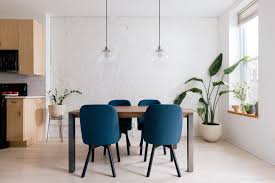 The side chairs with the wooden seat are polished in black color. Dining Chairs Apartment Therapy