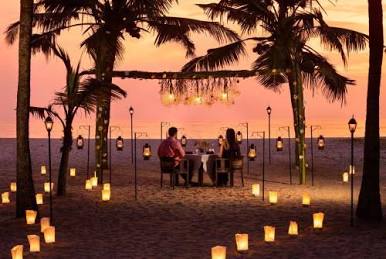 Candlelight beach dining in Marari., AI generated