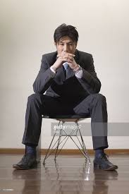 The man sitting on an invisible chair as with last sunday here's another illusion. Portrait Of A Businessman Sitting On The Chair Picture Id71155653 682 1024 Sitting Poses Sitting Pose Reference Boy Poses