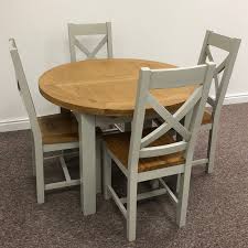 A classic matt white round dining table that seats 4 people, looks elegant with the eames style dining chairs. Dover Oak Grey Extending Round Dining Table 110 4 Chairs Moon Furniture