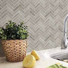 The latter was placed behind the oven for a practical reason, not just for a dramatic statement—tile is way more heat resistant than wood. Bath Wall And Floor Mosaic Tile Kitchen Backsplash Herringbone Marble Stone Gray