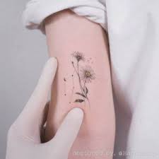 Among such a wide multiplicity of beauteous flowers, it is impossible not to distinguish a lovely daisy. Daisy Flower Tattoo Meaning And Designs Daisy Flower Tattoos Daisyflower Flowertattoos Cutetattoos Gemini Tattoo Gemini Tattoo Designs Tattoos