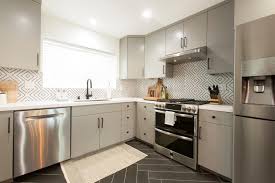 The open shelves are also black marble. Gray Mid Century Modern Kitchen With Black Tile Floor Hgtv