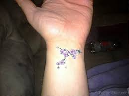 This graceful wrist tattoo features yet another moon design, but this time there is also a small stalk of flowers accompanying this moon tattoo. 80 Fantastic Dainty Tattoos On Wrist