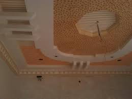 The contemporary pop ceiling is accentuated with sturdy wooden logs, which remind us of the typical old homes. Pop Ceiling Design Gharexpert