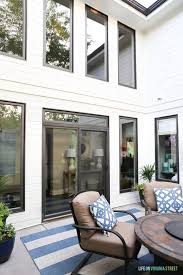 We did not find results for: Benjamin Moore White Dove Courtyard With Dark Window Trim The Space Is Accessorized With Blue And White Pillows House Exterior Dove House Benjamin Moore White