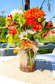 Explore pastryaffair's photos on flickr. White Orange And Green Wedding Flower Arrangements With Burlap Stock Photo Picture And Royalty Free Image Image 16857050