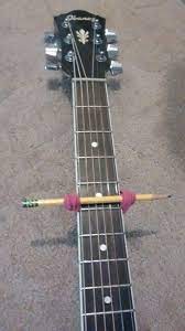 How To Make A Capo Diy Grab A Pencil Or Pen And Some Rubber Bands And Your Set Better Than Paying 15 Ukulele Music Instruments Diy Guitar