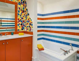 This space gains a playful edge from a patterned shower curtain and colorful bath accessories. Colorful Bathrooms Luxury Bathrooms