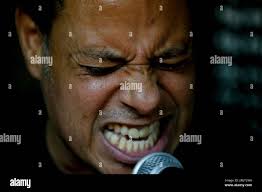In this May 29, 2019 photo, Horacio Blanco, lead singer and guitarist of  the Venezuelan ska band Desorden Público, grimaces during a practice  session at their studio in Caracas, Venezuela. Jammed into