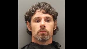 Man hangs onto mirror of school bus after trying to force his way onto the  bus, deputies say