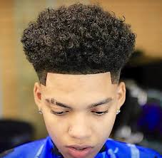 A great way to tame an afro, remove the hair from the face, while also finding a perfect curly hairstyle for boys is creating this high top long afro ponytail. Hairforguys Curlyhair Curly Hair Men Taper Fade Curly Hair Hair Styles