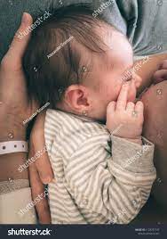 Cute Newborn Baby Showing Middle Finger While Drinking Milk From Mother S Breast