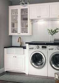 An On Trend Laundry Room Cardell Cornerstone Collection White Cabinets Bass Hardware White Glas White Laundry Rooms Modern Laundry Rooms Laundry Room Design